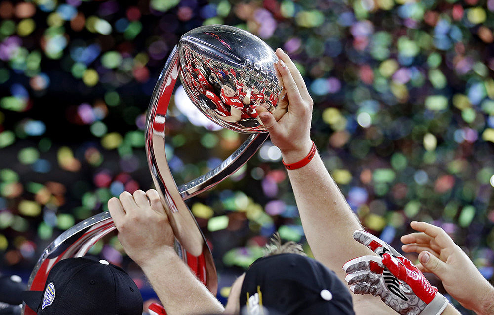 Sports Feature - 2nd place   - Ohio State holds up the Field Scovell Trophy after beating USC Trojans in the 82nd Cotton Bowl Classic at AT&T Stadium in Arlington, Texas. (Kyle Robertson / The Columbus Dispatch)